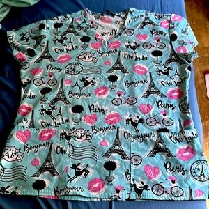 This is a Samantha Mara srub top. It’s light blue with pink and black